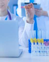 Laboratory assistant holding test tube.