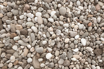 Background of sea pebbles. Abstract wallpaper of stones on the ocean. Multi-colored pebbles.