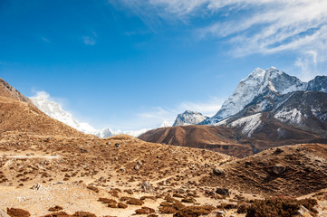 Fototapeta na wymiar Valley leading to the Everest base camp with Cholatse and Taboche peak. Trekking in Nepal Himalayas. EBC (Everest base camp trek) trail upper part from Lukla to EBC of Everest trek. Nepal.