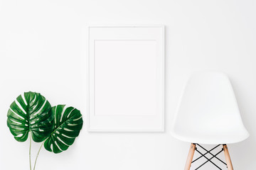 White art mockup on white wall with monstera leaves. Simple modern interior. Art template. Background. Print mockup, posyter mockup