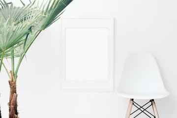 Palm and frame mockup on white wall. Simple modern interior. Art template. Background. Print mockup, posyter mockup