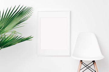 Palm and frame mockup on white wall. Simple modern interior. Art template. Background. Print mockup, posyter mockup