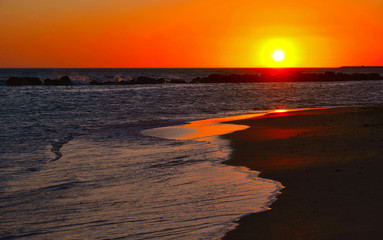 Orange Sunset Seascape with Mollarella sand beach (spiaggia di mollarella) near coastal city of Licata , SICILY Italy