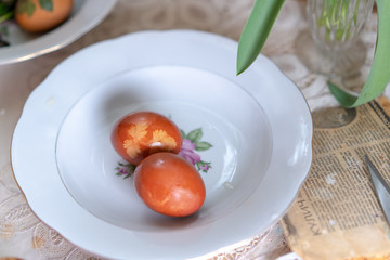 A painted egg with an ornament in a plate for Easter