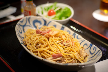 Dish of spaghetti carbonara white source with beacon and mushroom . Italian traditional food, served on the table. Selective focus photo.