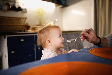 dad treats his child with porridge