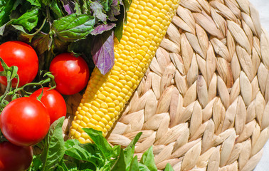 Raw vegetables close up. Top view of fresh tomatoes, basil, eggplant, red pepper and corn. Healthy eating concept, vegetable background. Selective focus image, flat lay. Copy space.