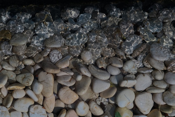 Pebble and glitter water ripple