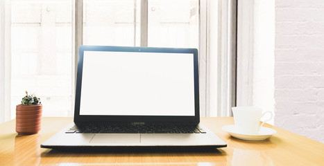 Fototapeta premium selective focus blank screen laptop,cactus and a cup of coffee on wooden table ,work online lifestyle relax at home