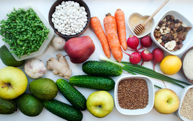 
Ingredients for cooking vegetarian food. Source of vegetable protein. Top view of healthy food clean nutrition vegetables, seeds, superfoods, leafy vegetables on a white background, cereals.
