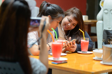 Group of young Asian women as friends hanging out together outdoors