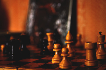 chess pieces on the vintage chessboard