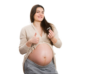 Happy pregnant woman making thumbs-up gesture and holding cigarette
