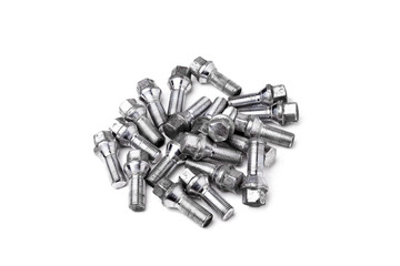 A handful of metal chrome bolts to fix the wheels of a car on a white isolated background in a photo studio. Spare consumables for replacing a wheel in a garage or workshop.