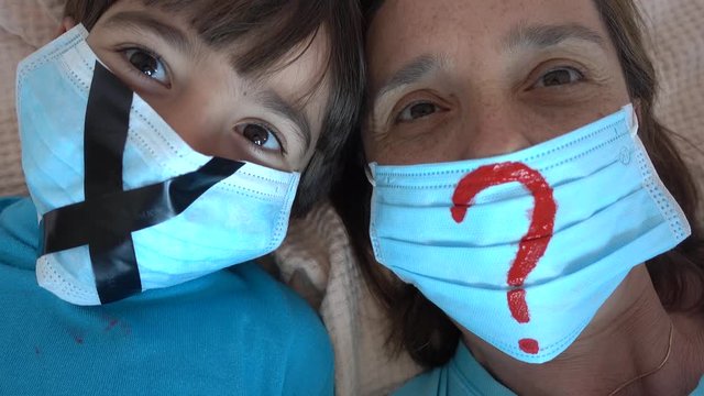 4K Close up Lockdown selfie of mother with child in masks protecting against compulsory isolation
