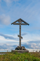Wooden orthodox cross against a bright sky