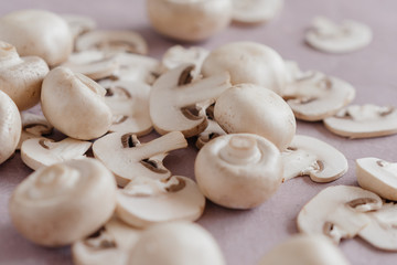 whole mushrooms and sliced ​​on a light pink background
