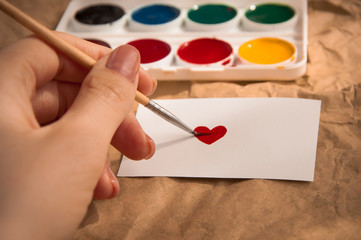colorful paints and brush post card with heart