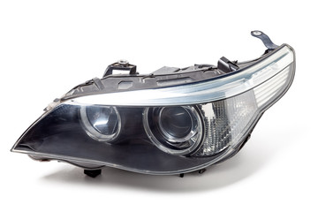 Stylish headlight of a German car with transparent glass - optical equipment with a lamp inside on...
