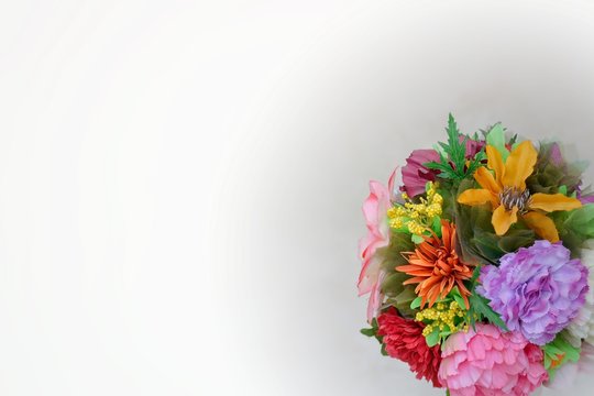 A round bouquet of different flowers on a neutral background. Place for text. Template for postcard, background, poster, site. Horizontal image format. High quality photo