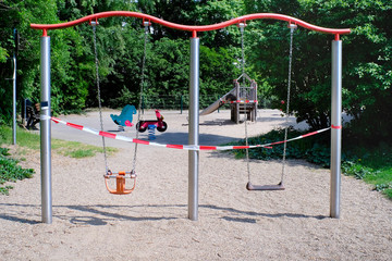 blocked swing, closed public children's playground,coronavirus lockdown