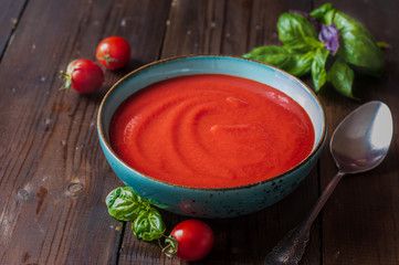 tomato soup in a plate wooden background