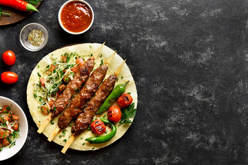 Adana Kebab with fresh vegetables on flatbread