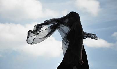 dark silhouette with a shawl