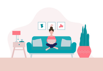Woman sitting on a sofa with laptop  in her living room in period of self isolation and social distancing during Covid-19 virus epidemic. Stay home concept. Freelance or studying concept.