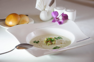 Obraz na płótnie Canvas salmon cream soup served with parsley