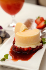 yellow ice cream with strawberries and mint leaves