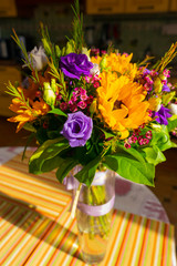 bouquet of sunflowers and purple roses