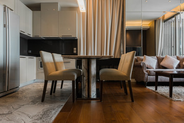 Stylish kitchen interior with dining table and chairs
