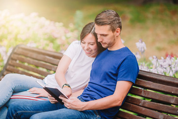 Relaxed young family on the bench in the park