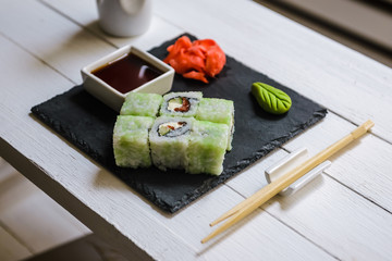 Japanese traditional rolls served in a sushi bar on white table. Sushi menu. Japanese food concept. Place for text