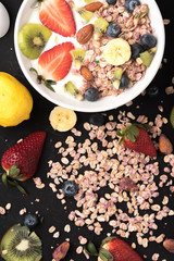Granola. Granola with yogurt, on black wooden table