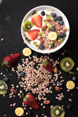 Granola. Granola with yogurt, on black wooden table