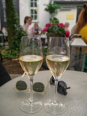 two glasses of champage on table with glasses