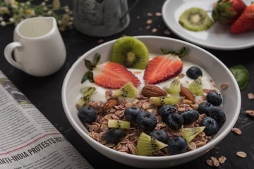 Granola. Granola with yogurt, on black wooden table