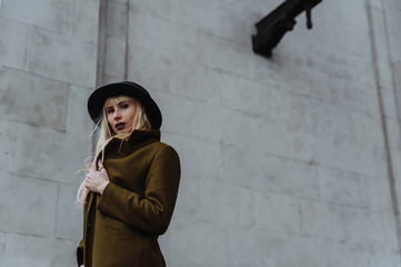 Blonde woman in the coat wearing the hat