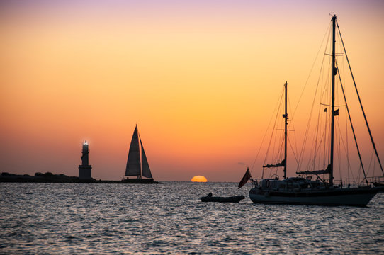 Sunset over the sea boats at anchor with a thousand colors. Panoramic sunset view Formentera island Spain, Vacation travel concept