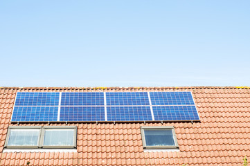 Solar panels on a large red roof for electric power generation