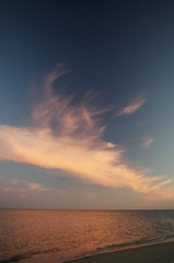 Seascape at sunset. Beautiful dark sky and light clouds