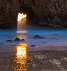 Sunset Through Portal in Pfeiffer Beach Arch at Pfeiffer Beach,Pfeiffer Big Sur State Park, Big Sur, California, USA