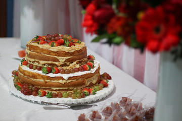 Birthday setup. Naked cake with red fruits