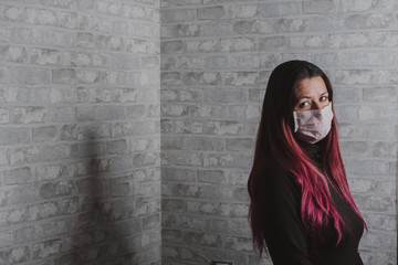 Modern young girl with surgical mask covering her mouth and nose, protecting hesitizing from the covid-19 virus. coronavirus 2020