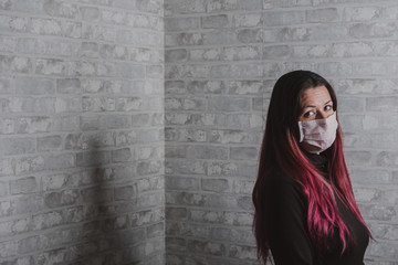 Modern young girl with surgical mask covering her mouth and nose, protecting hesitizing from the covid-19 virus. coronavirus 2020