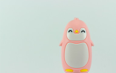 A color image of a pink and white baby penquin with a white background.