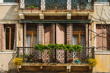 Fototapeta na wymiar Terrace in Venice with a floral Italian patio. Italian balcony with flowers.