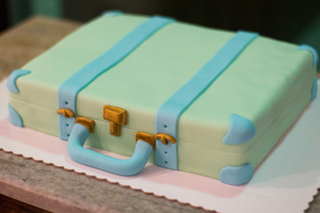 Suitcase shaped cake. Travel concept.